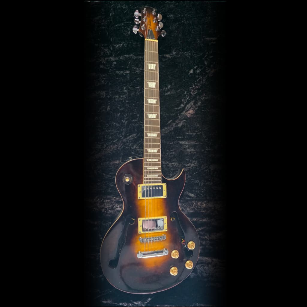 Close-up of a guitar body and hardware with a dark finish.