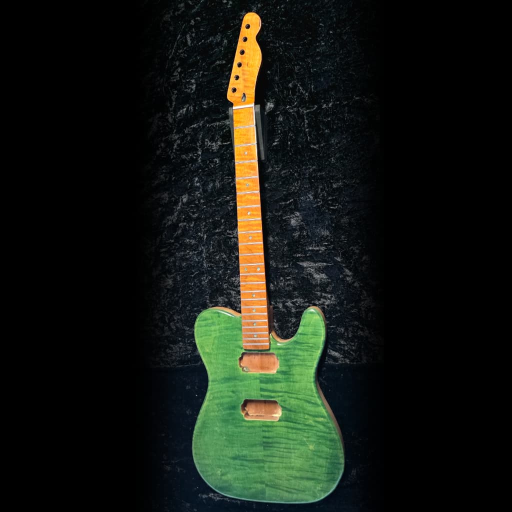 Workshop shot of a guitar on the bench during final setup.